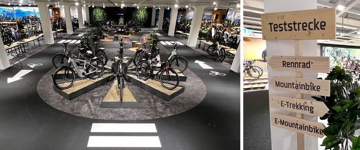 Fahrradgeschäft mit einer Auswahl an Fahrrädern in einem Kreis aufgestellt und einem Schild, das verschiedene Fahrradtypen und eine Teststrecke anzeigt.